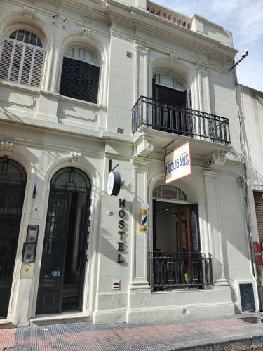 a white building with a sign on the side of it at WHY NOT NUEVA CORDOBA in Cordoba