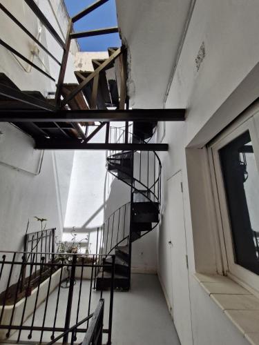 an empty room with a spiral staircase in a building at WHY NOT NUEVA CORDOBA in Cordoba