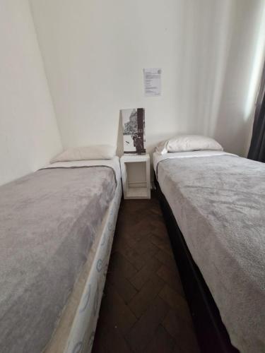 two beds sitting next to each other in a room at WHY NOT NUEVA CORDOBA in Cordoba