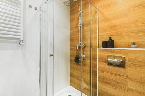 a shower with a glass door in a bathroom at Stylowe Apartamenty w Centrum in Wrocław