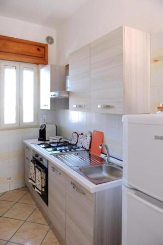a kitchen with a sink and a stove top oven at Le Residenze Salentine - Case Vacanza in Lecce in Lecce
