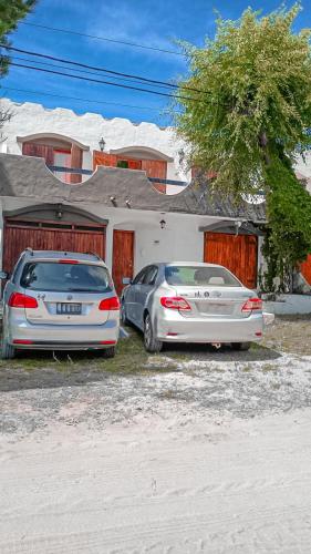 two cars parked in front of a house at Casa Sanbernardo costa azul muy grande in San Bernardo
