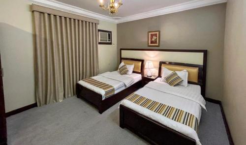 Katil atau katil-katil dalam bilik di AL Mokhmalia Serviced Apartments