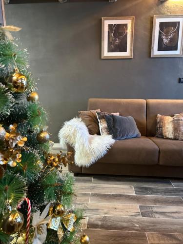 a living room with a christmas tree and a couch at Loft in Piazza Dodero A due passi dalle piste in Prato Nevoso