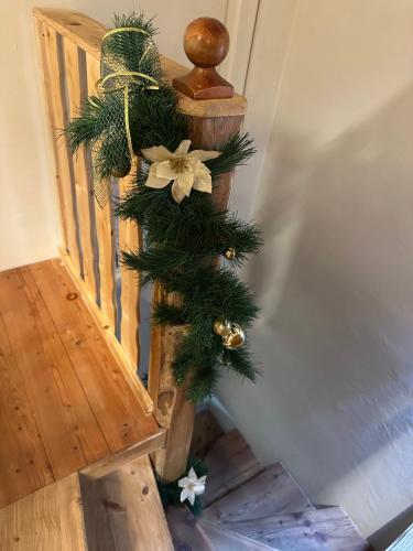 a christmas tree on the side of a staircase at Loft in Piazza Dodero A due passi dalle piste in Prato Nevoso
