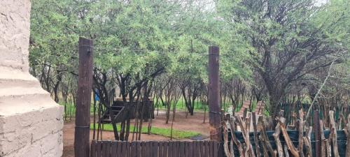 a wooden fence with trees in the background at Ada Selah in Bela-Bela