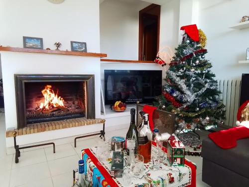 a living room with a christmas tree and a fireplace at Villa Max in Lloret de Mar