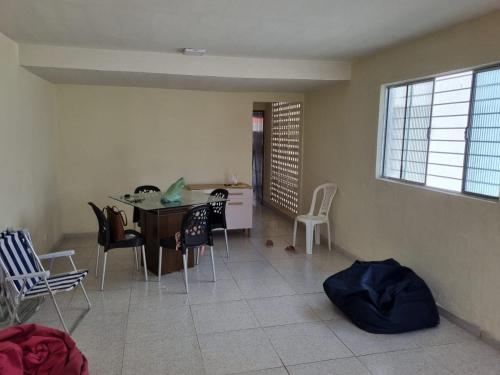 a living room with a table and chairs at Casa Eldorado in Itamaracá