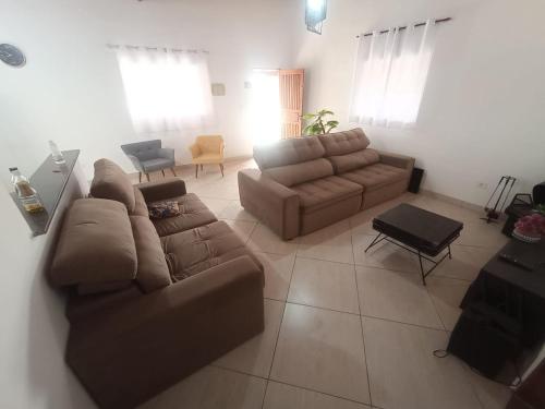 a living room with a couch and a table at Chácara Por do Sol - Mairinque in Mairinque
