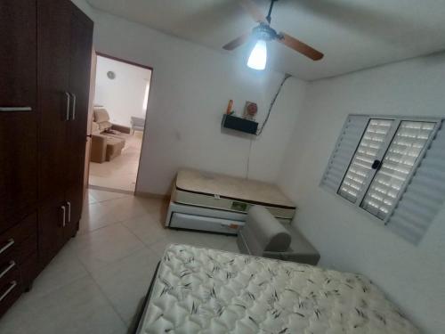 a bedroom with a bed and a ceiling fan at Chácara Por do Sol - Mairinque in Mairinque