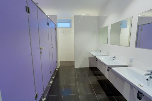 a bathroom with two sinks and a mirror at Comfort Hotel & Hostel in Zaporozhye