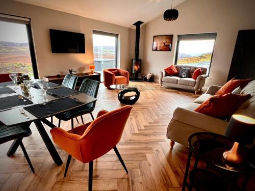 a large living room with a table and chairs at Luxury 3 Bedroom House - Stag Moor House in Portree