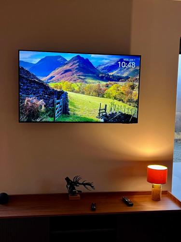 a flat screen tv hanging on a wall at Luxury 3 Bedroom House - Stag Moor House in Portree