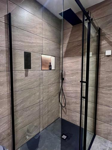 a shower with a glass door in a bathroom at Luxury 3 Bedroom House - Stag Moor House in Portree