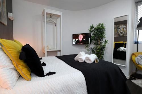 a bedroom with a bed with towels on it at Crescent Apartment in Eastbourne