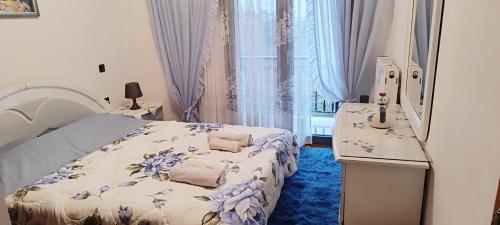 a bedroom with a bed and a table and a window at Pavlos House in Asfáka