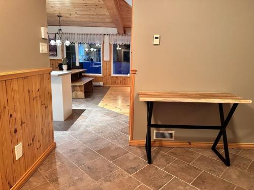 a kitchen with a wooden table and a counter at Le Grand Boisé in Saint Zenon