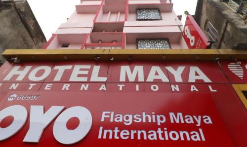 a sign for a hotel maya international sign in front of a building at Hotel O Home Cozy Studio Collage Square Hotel Maya International Near St. Thomas's Church in Kolkata