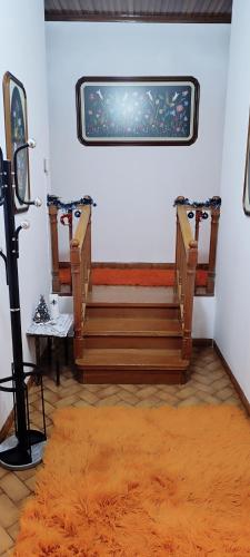 a room with two wooden benches and a rug at Pavlos House in Asfáka