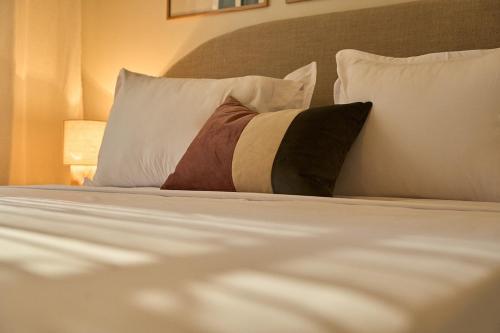 a close up of a bed with a pillow on it at Le Jardin Privé in Alger