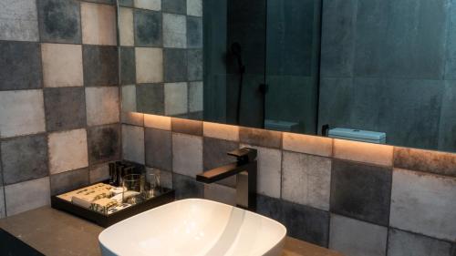 a bathroom with a sink and a mirror at EHBoutique Experience in El Calafate