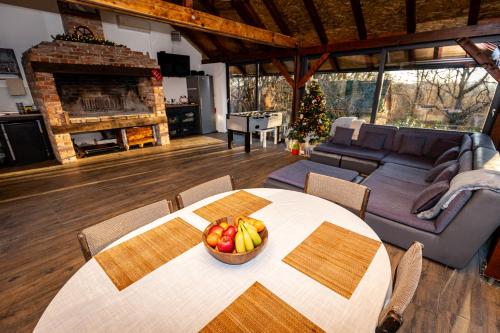 a living room with a table with a bowl of fruit on it at Kuća za odmor Natur in Brežane Lekeničke