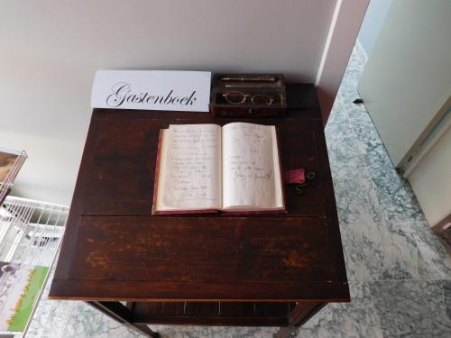 a table with two books and a box on it at Hotel Golden Dragon in Dessel