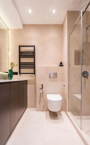a bathroom with a toilet and a shower at New Gudauri Neo Apartments in Gudauri