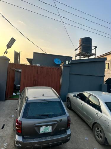 two cars are parked in a parking lot at 1Bedroom flat at Magnanimous Apartments Ogudu in Lagos