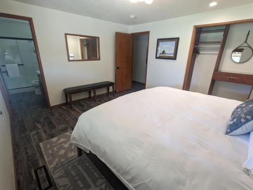 a bedroom with a large white bed and a mirror at Cozy Place for Family and Friends in Dundee