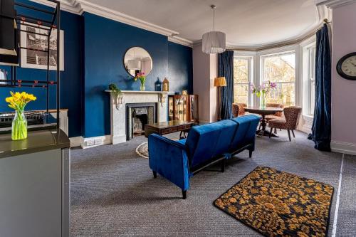 a living room with blue walls and a fireplace at The Harrison Chambers of Distinction in Belfast
