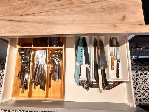 a drawer filled with lots of utensils at Herberk # 7 - A Modest Countryside Building in Chotiměř