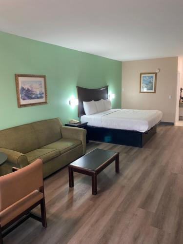 a hotel room with a bed and a couch at Security Inn and Suites in Lake City