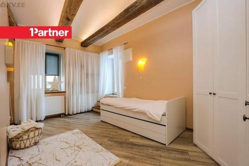 a bedroom with a white bed and a window at Kadriorgs Park House in Tallinn