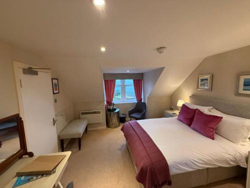 a hotel room with a large bed and a window at The Airds Hotel and Restaurant in Port Appin