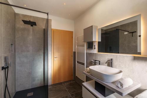 a bathroom with a sink and a shower at Ferienwohnungen Gamper in Tesimo