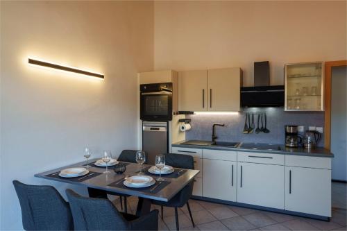 a kitchen with a table and chairs and a kitchen with a table and chairsktop at Ferienwohnungen Gamper in Tesimo