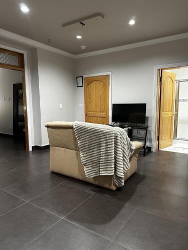 a living room with a couch with a blanket on it at Luxury Vancouver Suite Near YVR and Downtown in Vancouver
