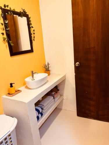 a bathroom with a sink and a mirror at Sol Vakantie Appartementen Curaçao in Willemstad