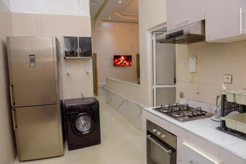 a kitchen with a refrigerator and a washing machine at Marrakech in Marrakech