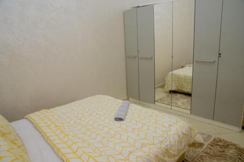 a bedroom with a bed and a mirror at Marrakech in Marrakech