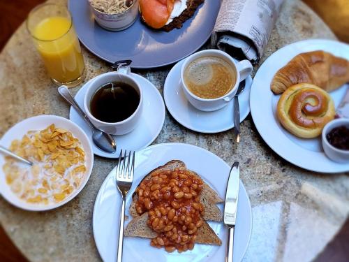 a table with plates of food and cups of coffee at Crews Bed and Breakfast in Dungarvan