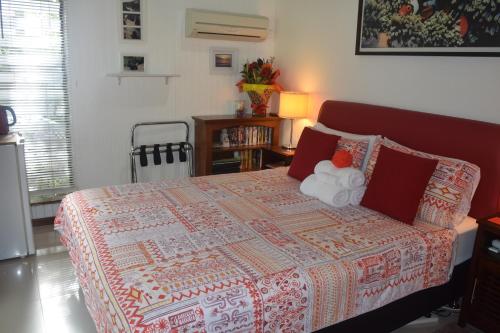 a bedroom with a bed with a quilt on it at South Pacific Bed & Breakfast in Clifton Beach