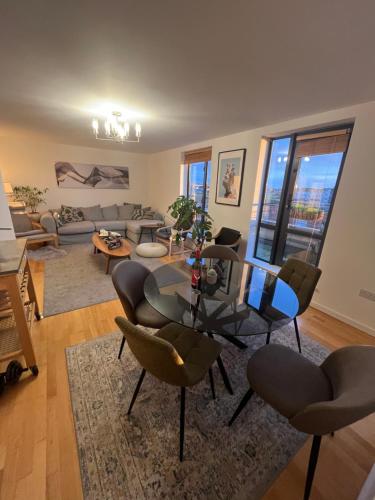 a living room with a table and chairs at Luxurious Entire Guest House with Grand Living Space and Panoramic Balcony Views in Dublin