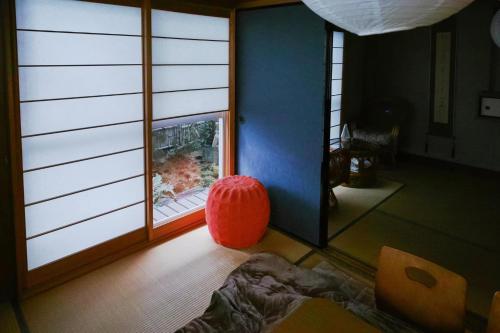 a room with a red ball sitting in front of a window at Vacation house月yue in Tokushima