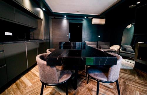 a dining room with a black table and chairs at Nissa la Bella in Nice