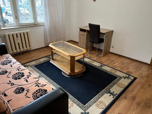 a room with a desk and a table and a chair at Alex Hac in Bacău