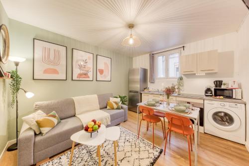 un salon avec un canapé et une table dans l'établissement Le Zenith, le calme et l'élégance proche Paris et Stade de France, à Saint-Denis