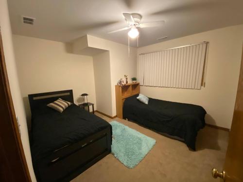 a bedroom with two beds and a ceiling fan at 3BR-2BA Deluxe Apartment with Fireplace and Balcony in Niles