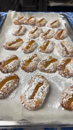 a group of powdered donuts sitting on a pan at Ines Apartments in Giardini Naxos